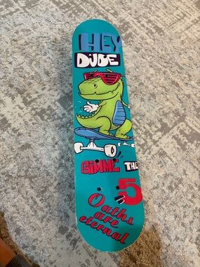 Kids Teal Skateboard Deck with Cartoon Dinosaur Graphic